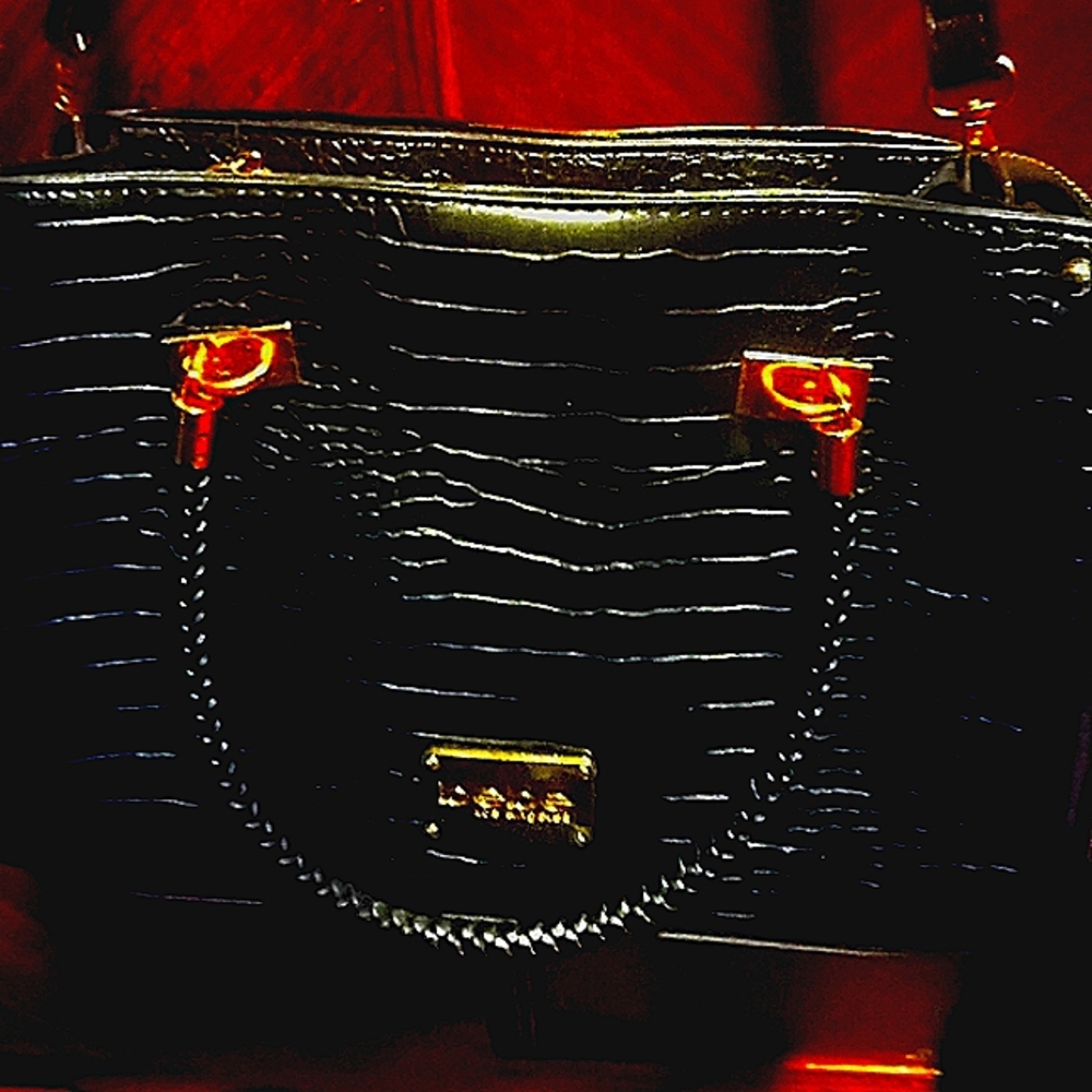Bebe Womans Pocket book.......Black with strap..